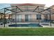 Screened in pool and spa with lounge chairs at 256 Sevilla Ave, Davenport, FL 33897