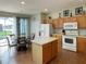 Bright kitchen with island, wood cabinets, and view of the pool at 256 Sevilla Ave, Davenport, FL 33897