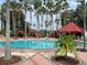 Community pool with cabanas and lush landscaping at 256 Sevilla Ave, Davenport, FL 33897