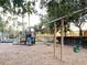 Play area with playset, swings, and wood chip surface at 256 Sevilla Ave, Davenport, FL 33897