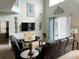 Living room with dark brown leather couches and sliding doors to the pool at 256 Sevilla Ave, Davenport, FL 33897