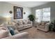 Living room featuring neutral colored couches and a large window at 256 Sevilla Ave, Davenport, FL 33897