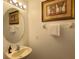 Small bathroom with a sink and round mirror at 256 Sevilla Ave, Davenport, FL 33897
