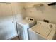 Laundry room with washer, dryer, and shelving at 256 Sevilla Ave, Davenport, FL 33897