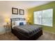Bedroom with a double bed and green accent wall at 256 Sevilla Ave, Davenport, FL 33897