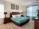 King-size bedroom with wood furniture and teal bedding at 256 Sevilla Ave, Davenport, FL 33897