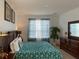 King-size bedroom with wood furniture and teal bedding at 256 Sevilla Ave, Davenport, FL 33897