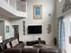 Living room with dark brown leather couches and a large TV at 256 Sevilla Ave, Davenport, FL 33897