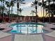Circular pool with plenty of lounge chairs and shade at 256 Sevilla Ave, Davenport, FL 33897