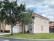 Two story house with tan exterior, tile roof and a two car garage at 256 Sevilla Ave, Davenport, FL 33897