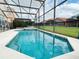 Inviting screened pool with spa and plenty of space for relaxing at 256 Sevilla Ave, Davenport, FL 33897