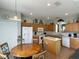 Eat-in kitchen with island, white appliances, and wood cabinets at 256 Sevilla Ave, Davenport, FL 33897