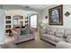 Spacious living room with light beige couches and built-in shelving at 256 Sevilla Ave, Davenport, FL 33897