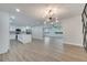 Open concept kitchen with island and modern white cabinets at 715 Eastover Cir, Deland, FL 32724