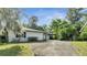 Side view of a ranch home with driveway at 715 Eastover Cir, Deland, FL 32724