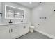 Modern bathroom with double vanity, large mirror, and walk-in shower at 715 Eastover Cir, Deland, FL 32724
