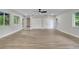 Open living space with hardwood floors and access to patio at 715 Eastover Cir, Deland, FL 32724