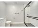 Updated bathroom featuring a walk-in shower and gray tile flooring at 715 Eastover Cir, Deland, FL 32724