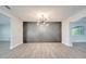 Elegant dining room featuring a geometric accent wall and chandelier at 715 Eastover Cir, Deland, FL 32724