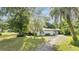 Side view of a ranch home with driveway at 715 Eastover Cir, Deland, FL 32724