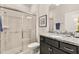 Clean bathroom with a walk-in shower, granite countertop, and dark vanity at 3525 Lavender Dr, Davenport, FL 33897