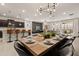 Open dining room with a wood table, modern lighting, and access to the kitchen at 3525 Lavender Dr, Davenport, FL 33897