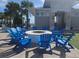Round fire pit with blue chairs near pool at 3525 Lavender Dr, Davenport, FL 33897