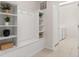 Bright laundry room with washer, dryer, shelving, and built-in bench at 3525 Lavender Dr, Davenport, FL 33897