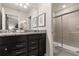 Elegant bathroom with granite countertops, dark cabinets, and a shower at 3525 Lavender Dr, Davenport, FL 33897