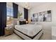 Cozy bedroom with a comfortable bed, dark blue curtains, and modern artwork at 3525 Lavender Dr, Davenport, FL 33897