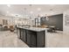 Modern kitchen with dark cabinetry, granite countertops, and a large island at 3525 Lavender Dr, Davenport, FL 33897