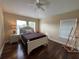 Cozy bedroom with hardwood floors, large windows, and a comfortable bed at 10791 Gran Paradiso Dr # S, Orlando, FL 32832