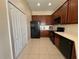 Well-equipped kitchen with dark wood cabinets and modern appliances at 10791 Gran Paradiso Dr # S, Orlando, FL 32832