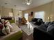 Open living room featuring comfortable seating and a large window at 10791 Gran Paradiso Dr # S, Orlando, FL 32832