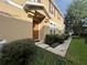 Tan townhome exterior with a walkway and landscaping at 10791 Gran Paradiso Dr # S, Orlando, FL 32832