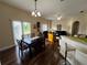 Bright dining area with dark wood table and chairs, overlooking a patio and trees at 10791 Gran Paradiso Dr # S, Orlando, FL 32832