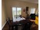 Bright dining area with dark wood table and chairs, overlooking a patio and water view at 10791 Gran Paradiso Dr # S, Orlando, FL 32832