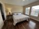 Main bedroom with laminate wood flooring, large windows, and a ceiling fan at 10791 Gran Paradiso Dr # S, Orlando, FL 32832