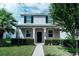 Two-story home with gray siding, black shutters, and a manicured lawn at 15031 Book Club Rd, Winter Garden, FL 34787