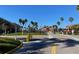 Gated community entrance with paved road and landscaping at 2210 Grand Cayman Ct # 1722, Kissimmee, FL 34741