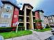 Attractive 3-story building with red and gray accents at 2210 Grand Cayman Ct # 1722, Kissimmee, FL 34741