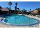 Community pool with ample lounge chairs at 2210 Grand Cayman Ct # 1722, Kissimmee, FL 34741