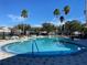 Inviting kidney-shaped swimming pool with surrounding lounge chairs at 2210 Grand Cayman Ct # 1722, Kissimmee, FL 34741