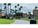 Paved road with lush green landscaping and palm trees at 2210 Grand Cayman Ct # 1722, Kissimmee, FL 34741