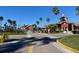 Gated community entrance with paved road and landscaping at 2210 Grand Cayman Ct # 1722, Kissimmee, FL 34741