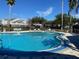 Refreshing community pool with lounge chairs and patio area at 2210 Grand Cayman Ct # 1722, Kissimmee, FL 34741