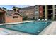 Community pool with surrounding lounge chairs at 2210 Grand Cayman Ct # 1722, Kissimmee, FL 34741