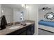 Bathroom with granite double vanity and a view of the bedroom at 9099 Hazard St, Davenport, FL 33896