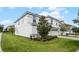 Two-story home with white exterior, landscaping, and a view of the side yard at 9099 Hazard St, Davenport, FL 33896