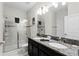 Elegant bathroom with double vanity and a large walk-in shower at 9099 Hazard St, Davenport, FL 33896